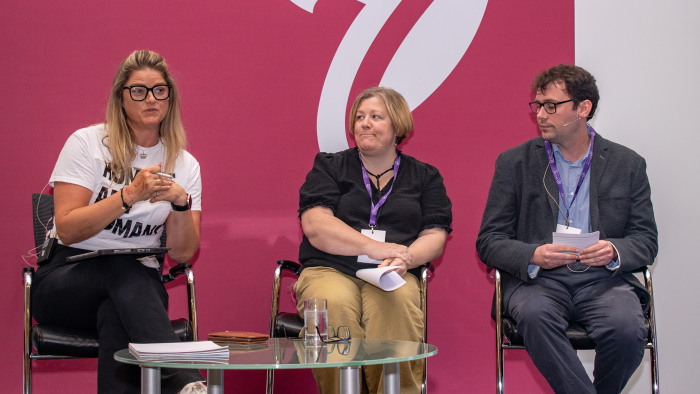 Panellists speaking on stage at the One Big conference.
